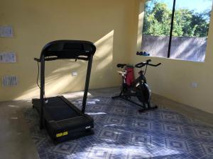 a room with a gym with a treadmill and a bike at The Pickled Onion Eco-Boutique B&B in Santa Elena