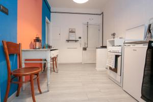 a kitchen with chairs and a table and a refrigerator at La casa di Marta in Genova