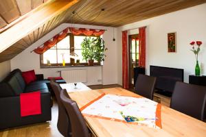 a living room with a table and a couch at Jakobsbauernhof in Freiamt