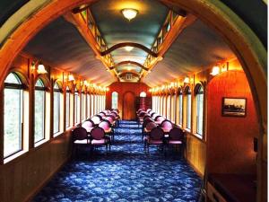 an empty train car with chairs and windows at Northern Queen Inn in Nevada City