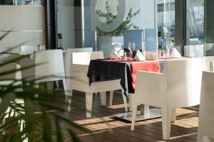 a dining room with a table with wine glasses on it at Nautic Hotel & Spa in Can Pastilla