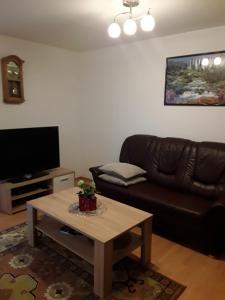 a living room with a couch and a coffee table at Ferienwohnung Mayer in Kirchheim am Ries
