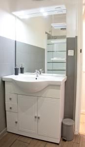 a bathroom with a white sink and a mirror at Le Poilu 40 m2 in La Ciotat +26 photos