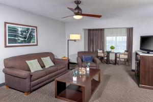 a living room filled with furniture and a tv at The Pierpont Inn in Ventura