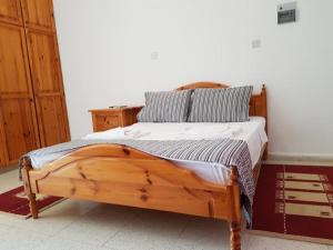 a bedroom with a wooden bed in a room at Paradise in Kyrenia