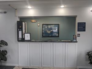 a counter in a room with a sign on the wall at Key West Inn - Childersburg in Childersburg