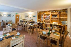 a restaurant with tables and chairs in a room at Tudor Lodge in Porthmadog