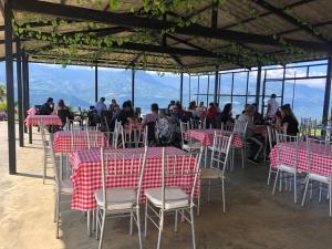 a restaurant with red and white tables and chairs at Altamira Biohotel in Socorro