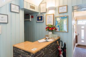 a desk in a room with a blue wall at Tudor Lodge in Porthmadog