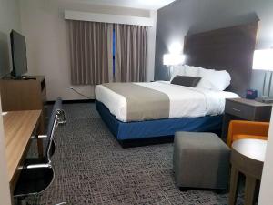 a hotel room with a bed and a television at Best Western Plus Wayland Hotel in Shelbyville