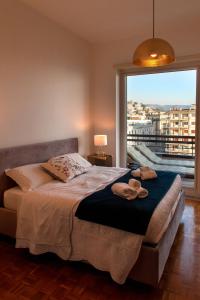 - une chambre avec un lit et une grande fenêtre dans l'établissement Mareluna Penthouse - Luxury Rooftop, à Salerne