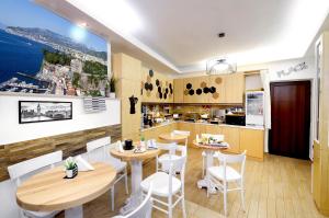 un ristorante con tavoli e sedie e una cucina di B&B Sorrento Queen a Sorrento