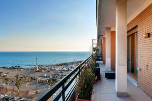 a balcony of a building with a view of the beach at Mareluna Penthouse - Luxury Rooftop in Salerno