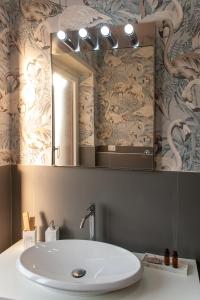 a bathroom with a sink and a mirror at Mareluna Penthouse - Luxury Suites & Rooftop in Salerno