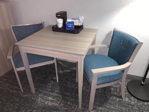 a table that has a drink and a bottle on it at Best Western West Lebanon-Hanover in West Lebanon