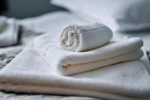 a pile of white towels sitting on a bed at Casa Mara in Ocna Şugatag +43 photos