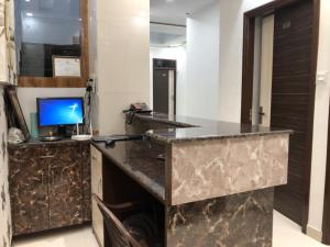 a kitchen with a granite counter top in a room at Shine star BnB in Amritsar