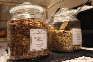 two jars of granola sitting on a counter at Hotel Garni Maximilian in Dingolfing