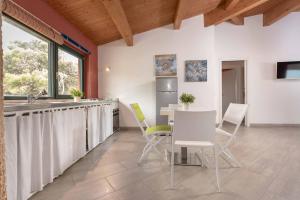 a kitchen with a sink and a table and chairs at La Rotonda Trilocale vista mare in Albinia