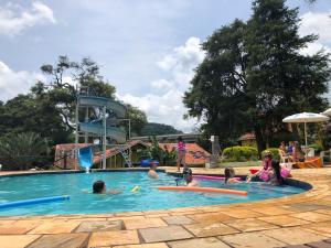 a group of people playing in a swimming pool at Marina e Pousada Porto do Sol in Nazaré Paulista