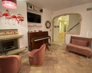 a living room with a piano and a mirror at DON GIL CHIC in Polignano a Mare