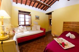 a bedroom with a bed and a table with a plate of food at Podere L'Istrice in Massa e Cozzile