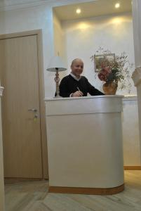 a woman standing behind a counter in a room at B&B Rome With Love in Rome