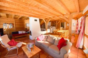 a living room with a couch and a table at Le Troll Hameau des Chazals Nevache Hautes Alpes in Névache