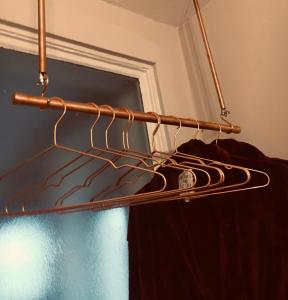 a rack of clothes in a room with a window at The Carrick in Portrush