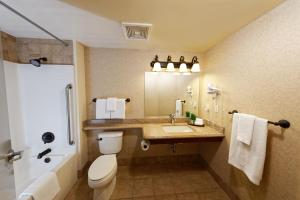 a bathroom with a toilet a sink and a mirror at Silver Sevens Hotel & Casino in Las Vegas