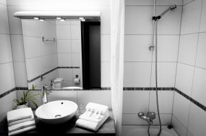 a bathroom with a sink and a mirror at Havila Hotel Geiranger in Geiranger