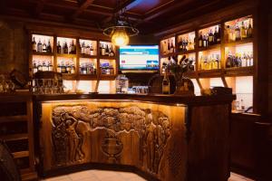 a bar with a wooden wall with a carving on it at Brilant Antik Hotel in Tirana