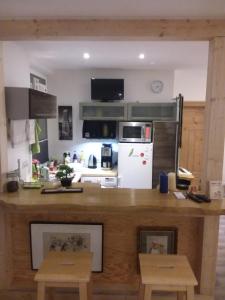 a kitchen with a counter and a white refrigerator at Ferienwohnung Casa Corleone in Apolda