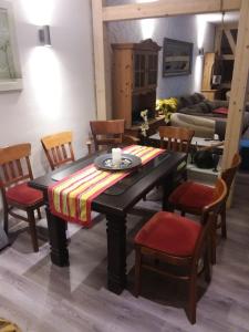a dining room with a table and chairs and a couch at Ferienwohnung Casa Corleone in Apolda