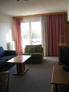 a living room with a couch and a table at Holiday Apartments Warmbad in Villach