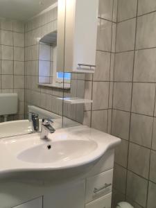 a bathroom with a white sink and a mirror at FEWO Appartement 4 in Minden