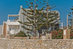 a white house with trees in front of it at Kalimera Karpathos Exclusive Villas in Afiartis
