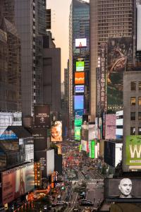 a busy city street in a city with tall buildings at M Social Hotel Times Square New York in New York