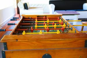 a set of wooden snooker tables with yellow and red pins at Casa de Campo Magnifica in Piracicaba