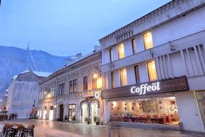 a building with a cotool sign on the side of it at Nani Nani Boutique in Braşov