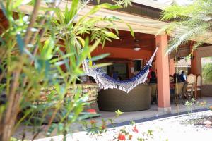 a hammock on the porch of a restaurant at Casa de Campo Magnifica in Piracicaba
