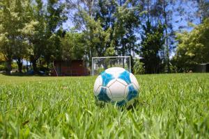 a soccer ball in the grass in front of a goal at Casa de Campo Magnifica in Piracicaba