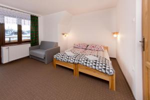 Ένα ή περισσότερα κρεβάτια σε δωμάτιο στο Pokoje "u Kuruców"