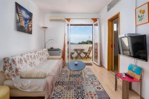 a living room with a couch and a tv at Apartments Pilicari in Rovinj
