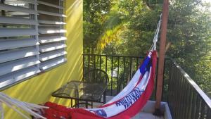 a hammock on a balcony with an american flag at Peña's Palalace Mayagüez in Mayaguez
