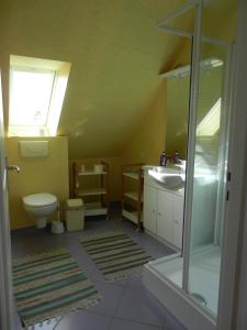 a bathroom with a toilet and a sink at VILLA THEDIEBERT in Barneville-Carteret +22 photos
