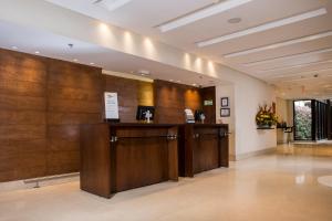 a lobby with wooden walls and a row of cabinets at Mercure Bogota Calle 100 in Bogotá