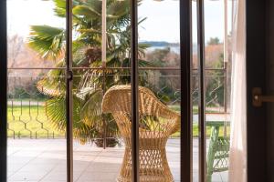 a wicker chair sitting on a porch looking out a window at Apartments Pilicari in Rovinj