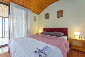 Postel nebo postele na pokoji v ubytování Apartments Pilicari