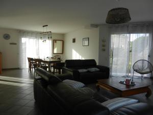 a living room with a couch and a table at VILLA THEDIEBERT in Barneville-Carteret